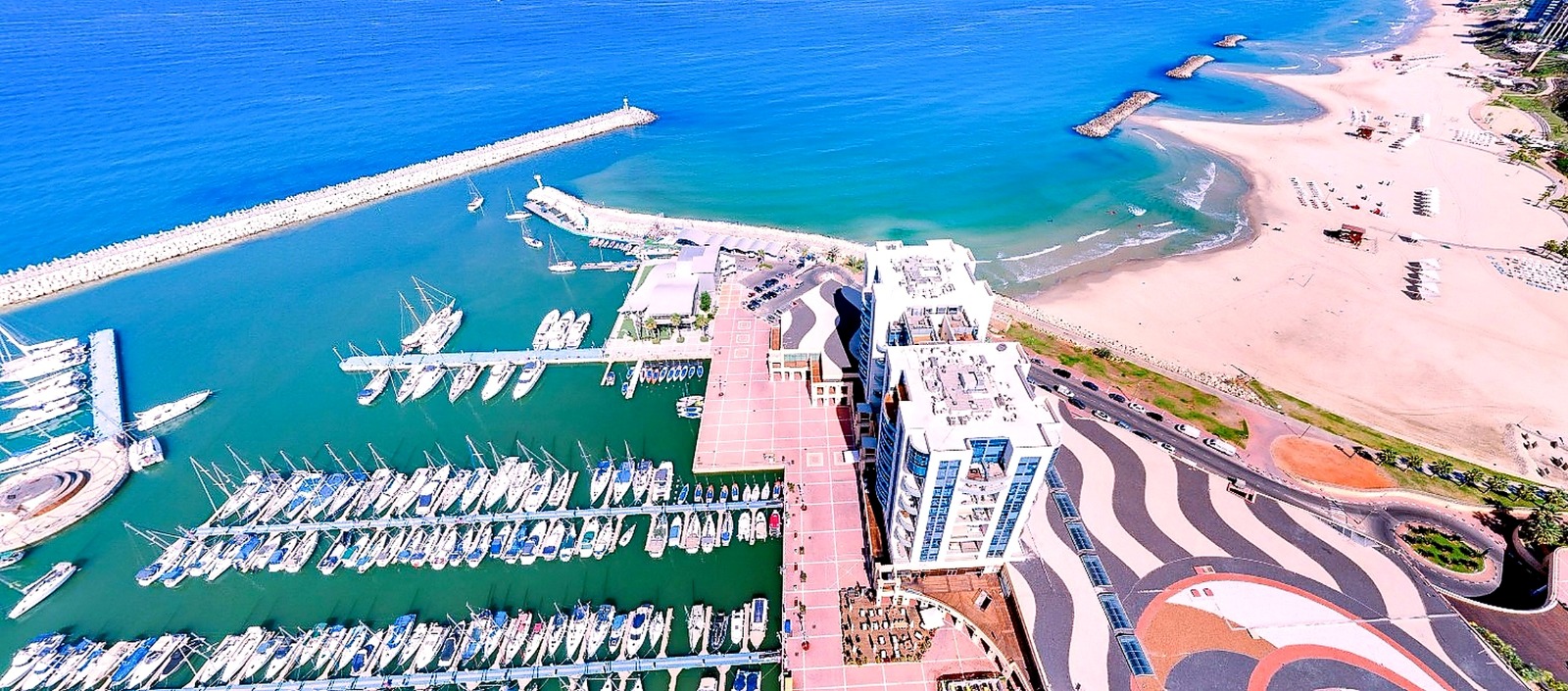 Aerial view of Herzliya Marina Towers, the marina berths and the Mediterranean coastline